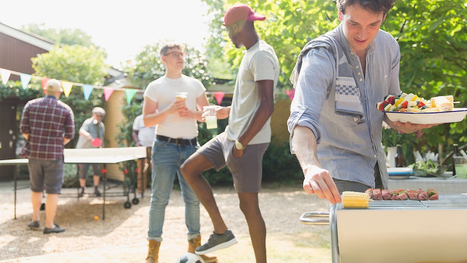 Backyard gathering with games and grilling