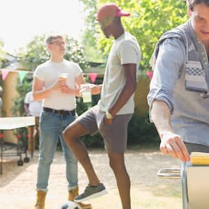 Backyard gathering with games and grilling