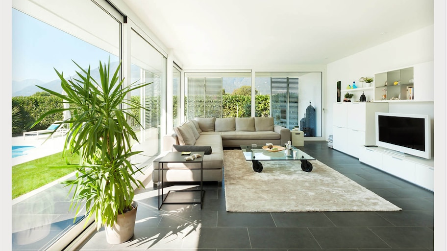 poolside sunroom with couch and TV