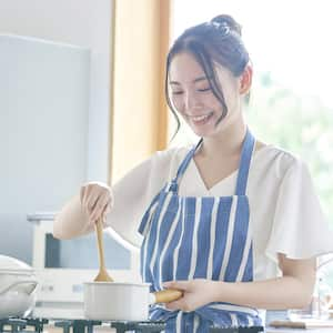 A woman cooking on a gas stove