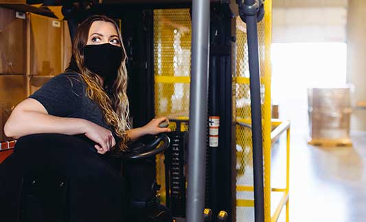 warehouse_worker_on_forklift_looking_backward