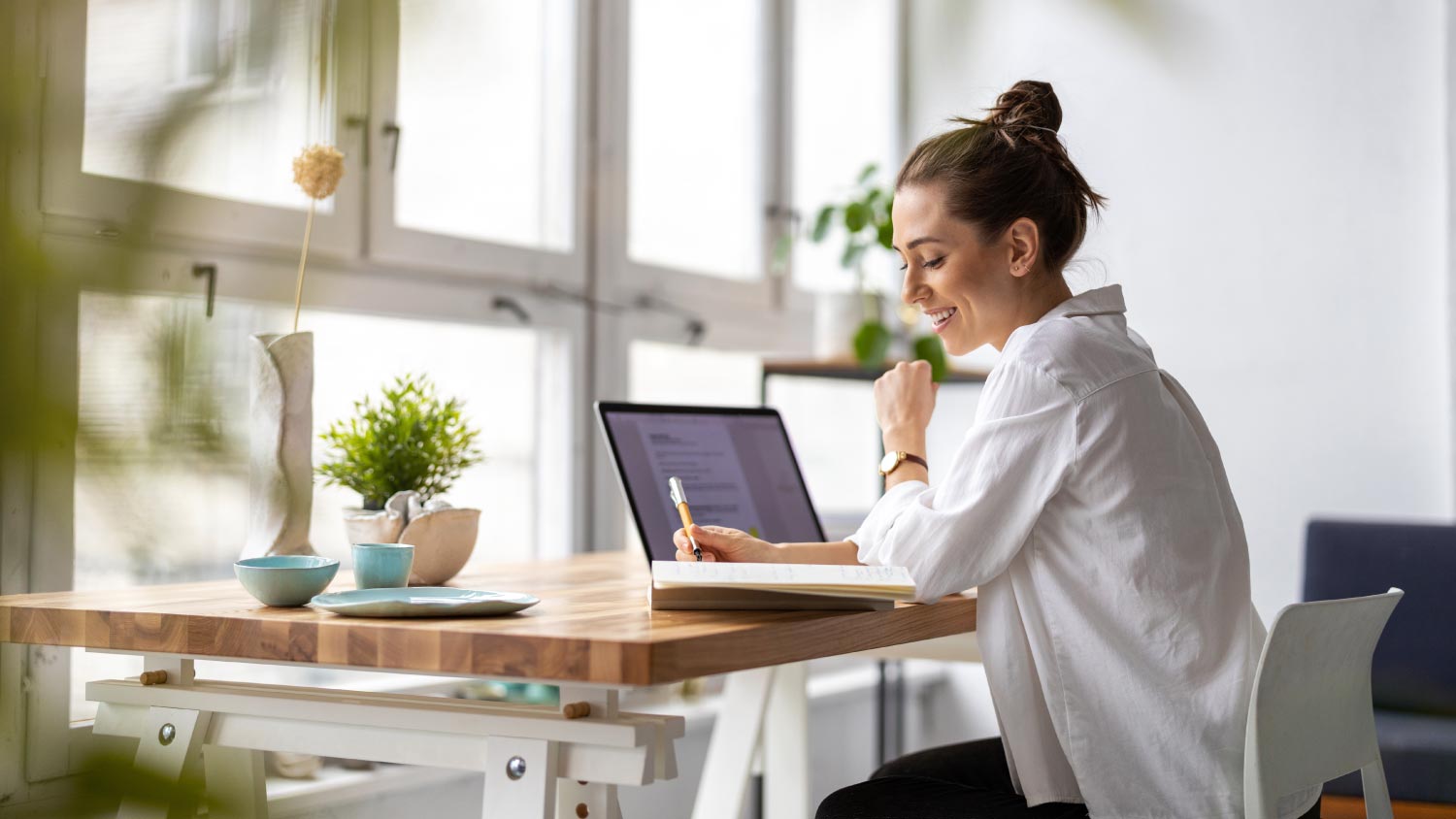 woman working on laptop in her home office 