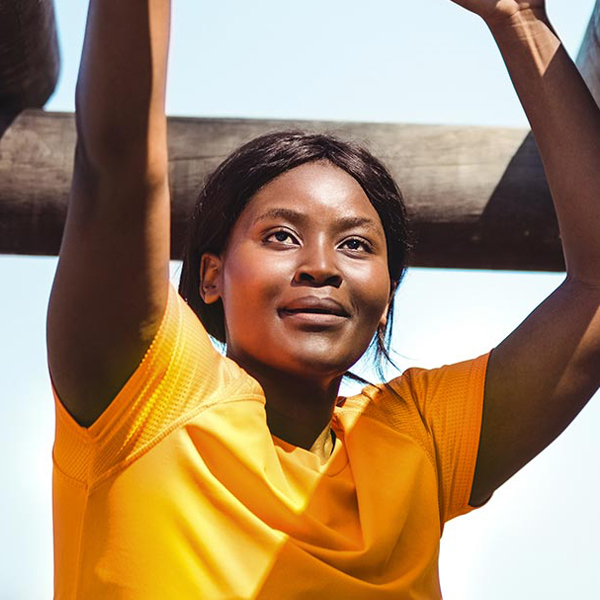 Photo of a woman working her way across monkey bars