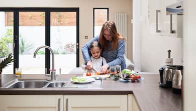 Mother and daughter at kitchen counter