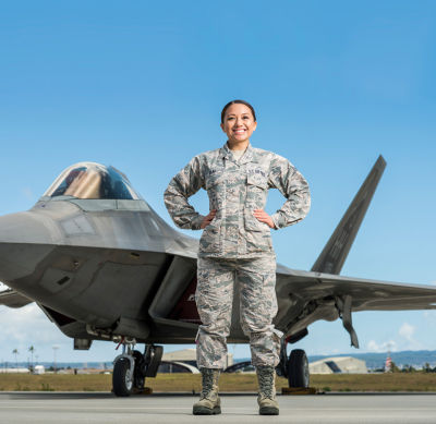 Image of active duty air force in front of plane