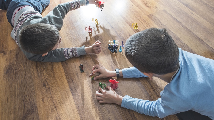 Boys playing with toys on vinyl flooring