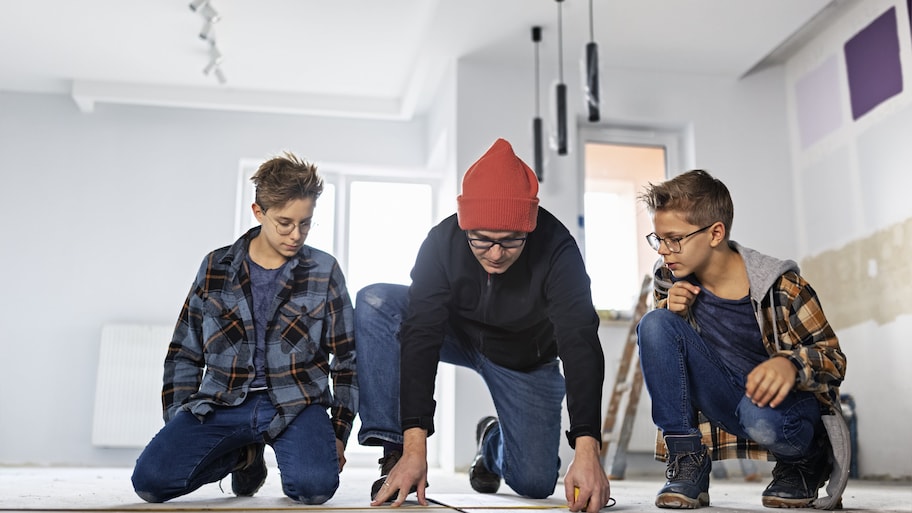 Father and sons planning to install vinyl planks