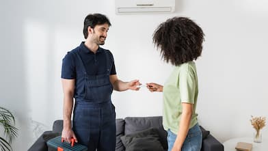 handyman giving business card to woman