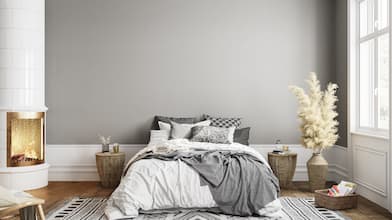 a furnished bedroom with gray walls