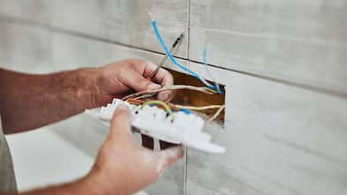 Electrician fixing wires of an outlet