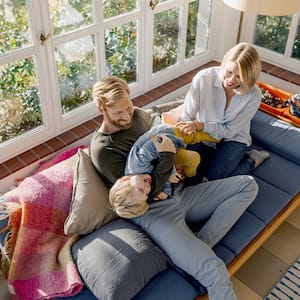 family playing on couch in sunroom