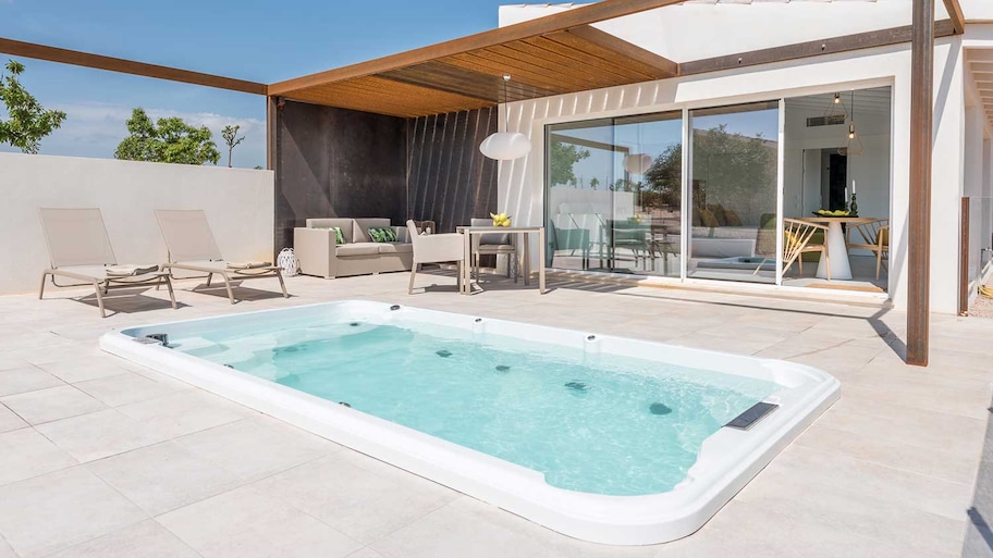 Luxury patio with an in ground hot tub