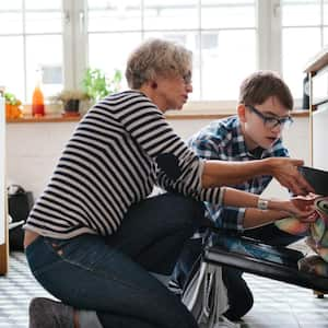 Mother teaching her son how to bake