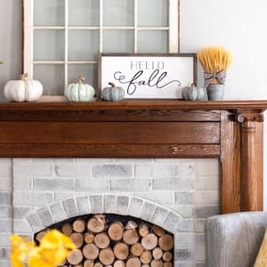 A fireplace with a wooden mantel
