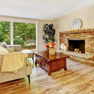  A spacious living room with a big brick fireplace