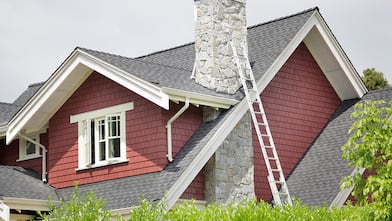 Ladder against house with chimney