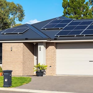 The exterior of a house with solar panels on the roof and a garage