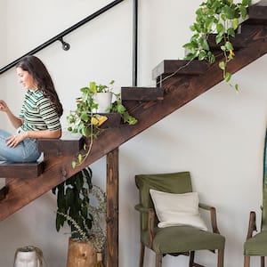 A woman sits on a staircase