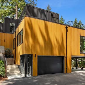 Modern house with linear design surrounded by trees