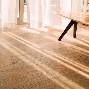 A sunlit modern living room with laminate flooring