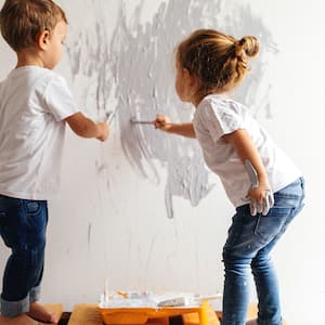 boy and girl painting a wall
