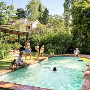 A family plays by a swimming pool