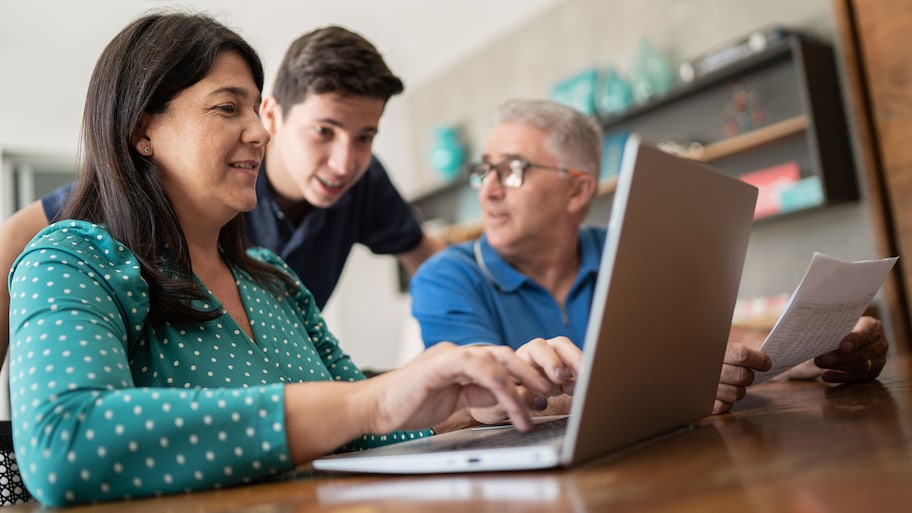 Parents and teenager son doing home finances at home