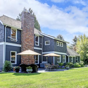 large blue house with large backyard