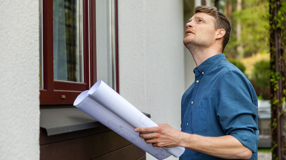 inspector examining home exterior