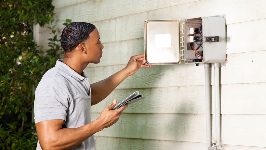 man examining home electrical box