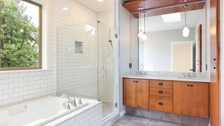 Modern bathroom with white subway tile and wood cabinets