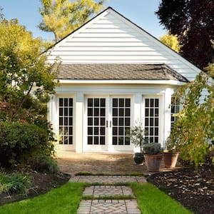 A cottage house with a landscaped backyard