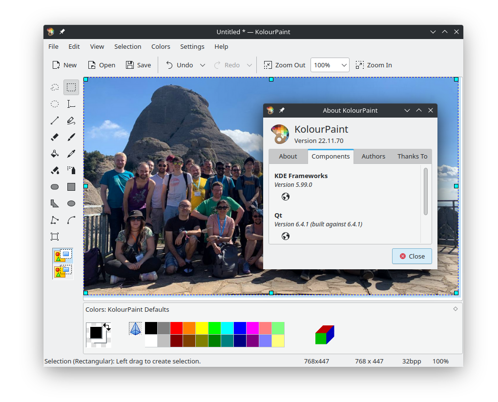 KDE’s painting application Kolourpaint showing a group photo of the Akademy daytripe hike with its version dialog in the front reading “Components: KDE Frameworks Version 5.99.0, Qt Version 6.4.1 (built against 6.4.1)”