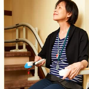 senior woman in stair lift seat