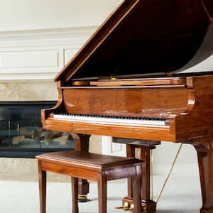 Grand piano in living room with fireplace