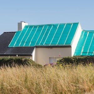 A house roof covered with tarp