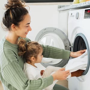 A mother and child do laundry