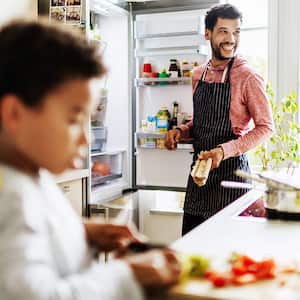 Man and boy kitchen prep food refrigerator