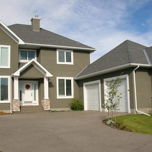 Two-story stucco house with concrete drive