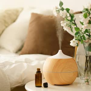 Aroma oil diffuser on chair against in the bedroom