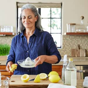 woman in the kitchen making natural cleaning products 