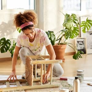 A woman cleaning a wooden chair