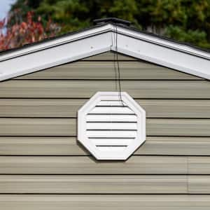 The exterior wall of a house with an attic fan