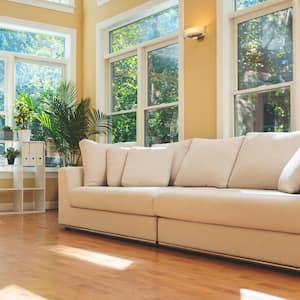 A sunlit living room with large windows