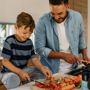 father and son cooking together in the kitchen   