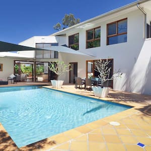 House with a backyard swimming pool and terracotta floor