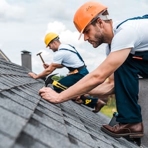 Men working on roof of a home