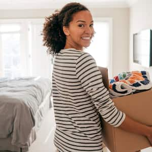 woman gathering clothes in box