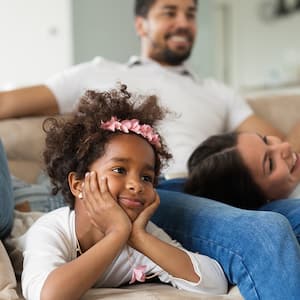 family relaxing at home watching tv  