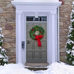 A Christmas wreath on the front door of a house